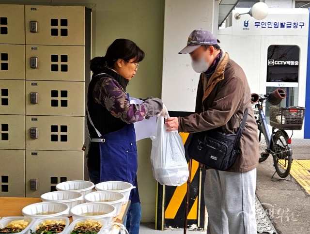 ▲ 사래울 쿡사랑 봉사단원이 따뜻한 명절 음식을 역곡2동 어려운 이웃에게 전달하고 있다.
