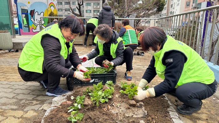 2-3. 동 단체원들이 청사 화단에 봄꽃을 심고 있다.jpg